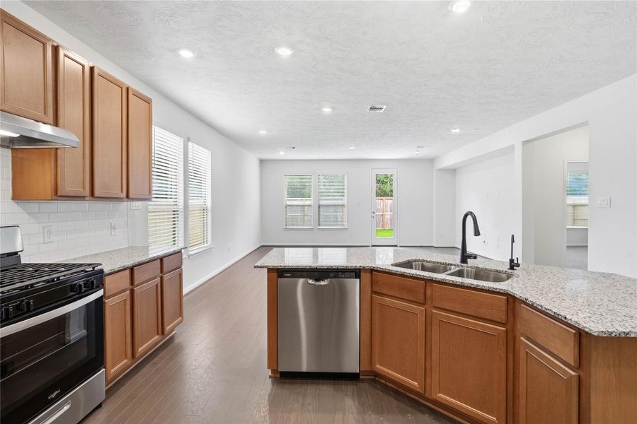 The heart of this home is bathed in abundant natural light and creates a bright, airy atmosphere that enhances the entire open-concept living area. The heart of this home is bathed in abundant natural light and creates a bright, airy atmosphere that enhances the entire open-concept living area.