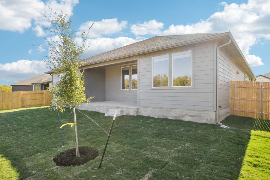 Rear view of property featuring a fenced backyard and a patio area