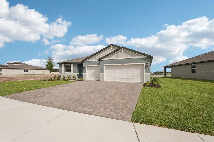 Front exterior of a new home in Oakfield Trails - Signature Series, Parrish, FL, highlighting curb appeal (Image 18).