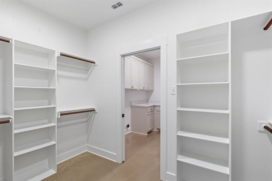 Spacious closet with light carpet