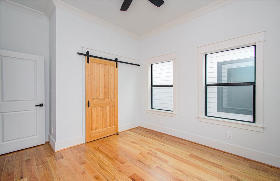 Bright Third Bedroom features hardwood floors, large windows for natural light.