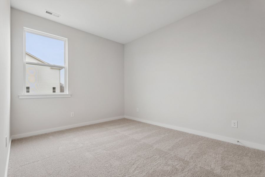 A room with a window and carpet. A room with a window and carpet.