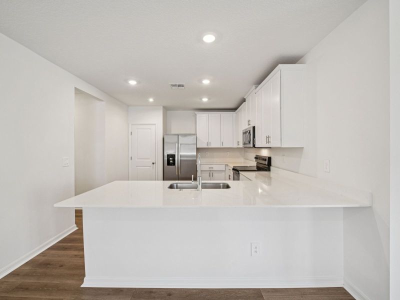 Furnished interior view inside a new home in Ridgehaven - Villas, Ormond Beach (Image 5).