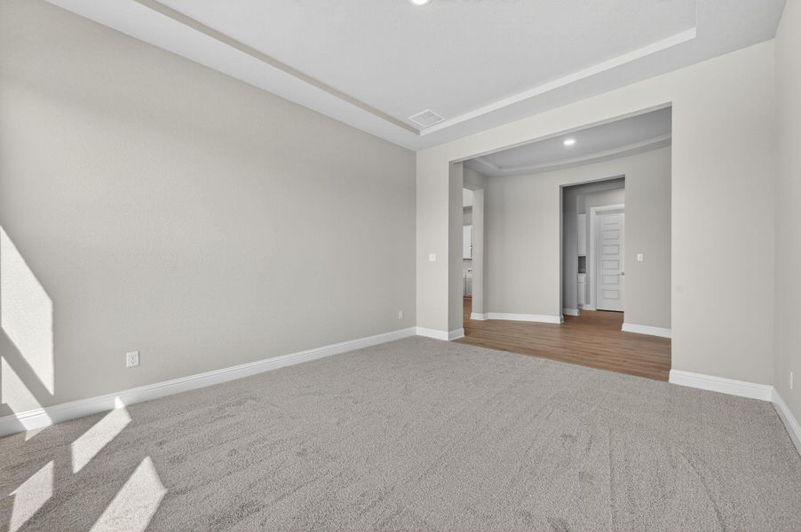 Carpeted spare room featuring baseboards and recessed lighting