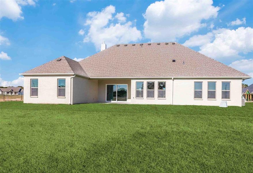 Back of property featuring a patio, a yard, roof with shingles, and stucco siding Back of property featuring a patio, a yard, roof with shingles, and stucco siding