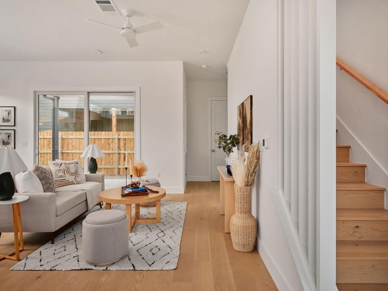 Living room with a ceiling fan and light wood-style floors