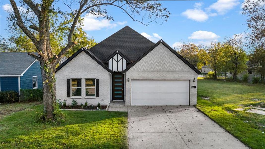 View of front facade with a front yard and a garage