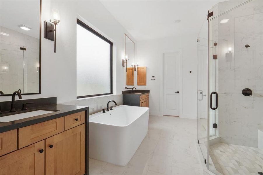 SAMPLE Luxurious Main bath features enlarged shower with two shower heads, soaker tub and waterfall porcelain counters adorned with elagant sconces above seperate vanties.