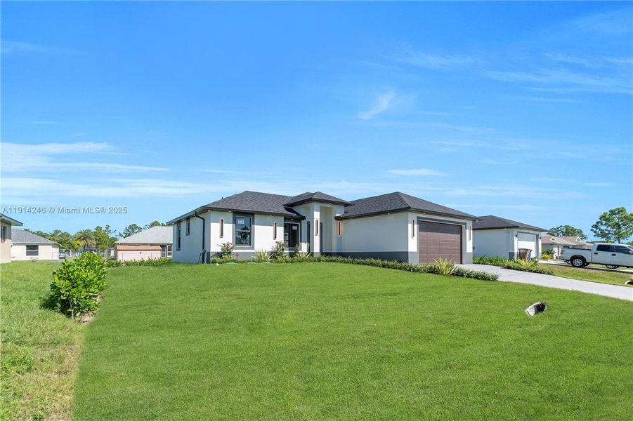 Front exterior of a new home in , Lehigh Acres, FL, highlighting curb appeal (Image 21). Front exterior of a new home in , Lehigh Acres, FL, highlighting curb appeal (Image 21).
