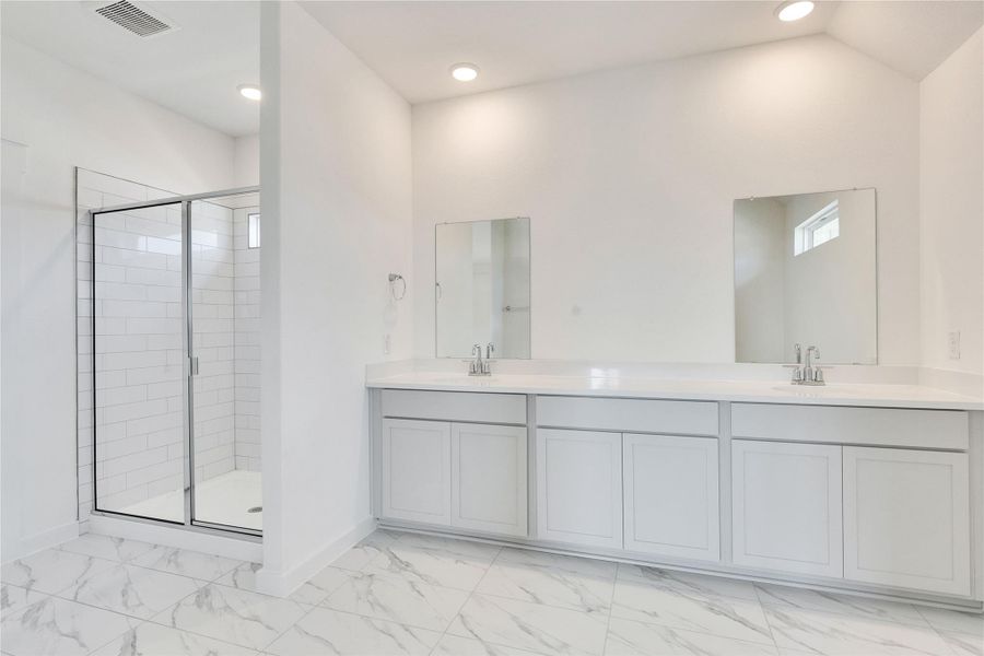 Full bathroom with a shower stall, double vanity, light marble finish floors, and recessed lighting Full bathroom with a shower stall, double vanity, light marble finish floors, and recessed lighting