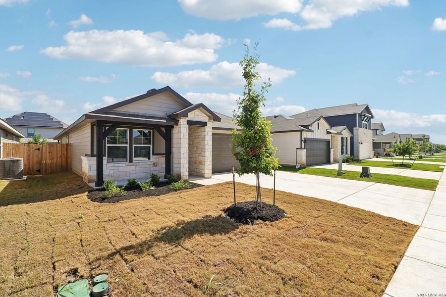 Front exterior of a new home in Estancia Ranch - Premier Series, San Antonio, TX, highlighting curb appeal (Image 23).