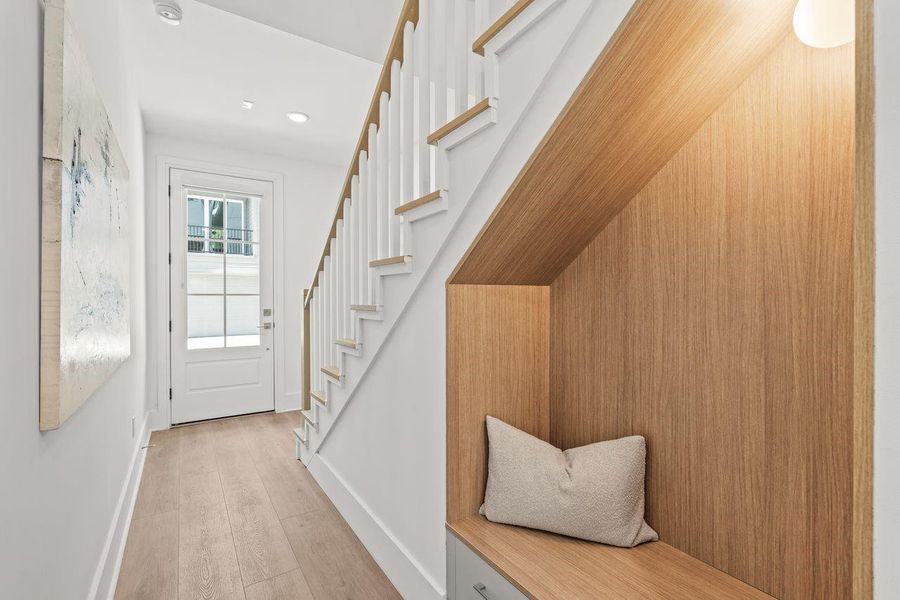 A thoughtfully integrated entry mud area provides everyday functionality, while a tucked-away nook introduces visual depth and functional versatility adds dimension and purpose, reinforcing the home's cohesive architectural language.
