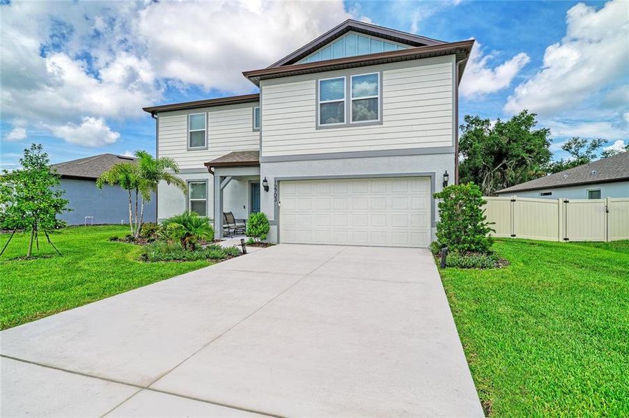Front exterior of a new home in Oakfield Lakes, Parrish, FL, highlighting curb appeal (Image 22). Front exterior of a new home in Oakfield Lakes, Parrish, FL, highlighting curb appeal (Image 22).