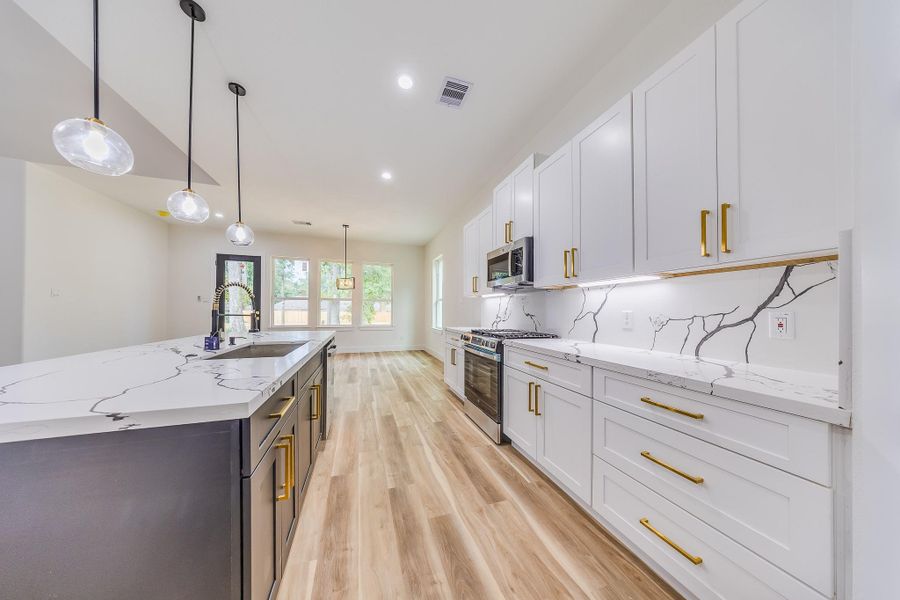Kitchen features sleek white cabinetry, providing a clean, modern look with ample storage and a bright, inviting atmosphere. Kitchen features sleek white cabinetry, providing a clean, modern look with ample storage and a bright, inviting atmosphere.