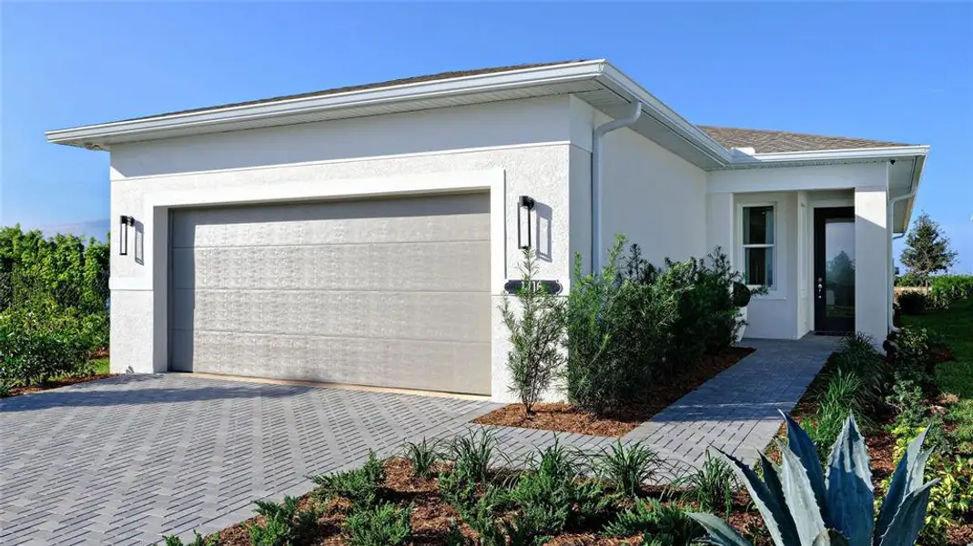 Front exterior of a new home in Cresswind at Lake Harris, Tavares, FL, highlighting curb appeal (Image 1). Front exterior of a new home in Cresswind at Lake Harris, Tavares, FL, highlighting curb appeal (Image 1).