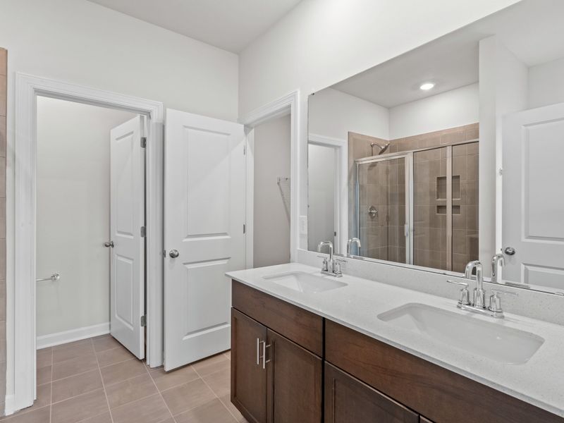 The primary suite boasts a private ensuite with dual sinks and walk-in closet.