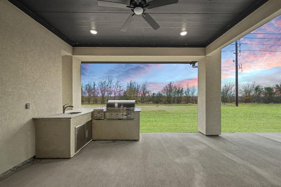 Enjoy entertaining under this fantastic covered patio with a ceiling fan to keep your cooler during the warmer months.