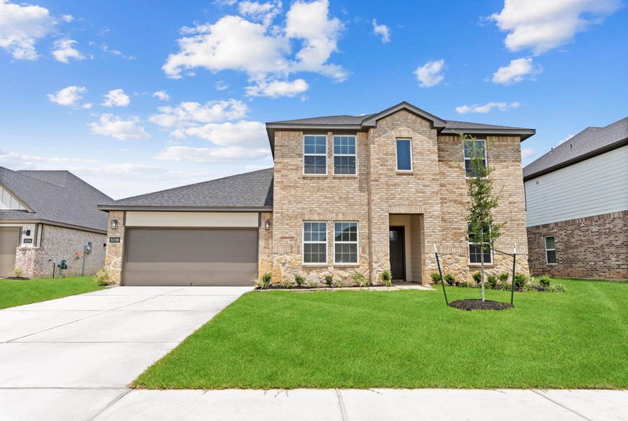Front exterior of a new home in Tamarron, Fulshear, TX, highlighting curb appeal (Image 26). Front exterior of a new home in Tamarron, Fulshear, TX, highlighting curb appeal (Image 26).