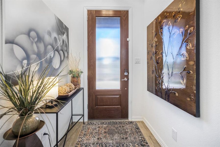 Entryway with wood finished floors Entryway with wood finished floors