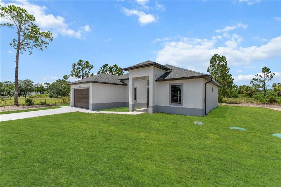 Front exterior of a new home in , Labelle, FL, highlighting curb appeal (Image 2). Front exterior of a new home in , Labelle, FL, highlighting curb appeal (Image 2).