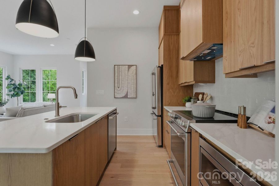 Custom white oak cabinetry with GE Cafe Series appliances