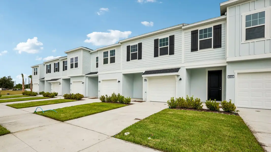 Front exterior of a new home in Twin Oaks, Zephyrhills, FL, highlighting curb appeal (Image 2). Front exterior of a new home in Twin Oaks, Zephyrhills, FL, highlighting curb appeal (Image 2).