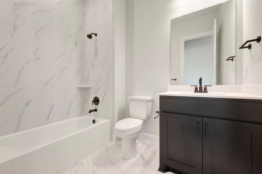 Full bathroom with vanity,  shower combination, and light marble finish floors