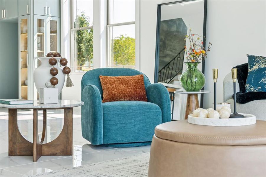 Living area featuring marble finish flooring Living area featuring marble finish flooring