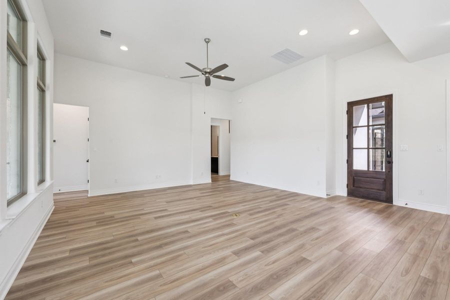 Unfurnished living room with recessed lighting, light wood-style floors, and a ceiling fan