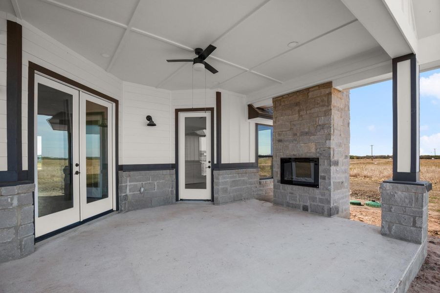 A spacious covered patio features a stone fireplace, perfect for outdoor entertaining. A spacious covered patio features a stone fireplace, perfect for outdoor entertaining.