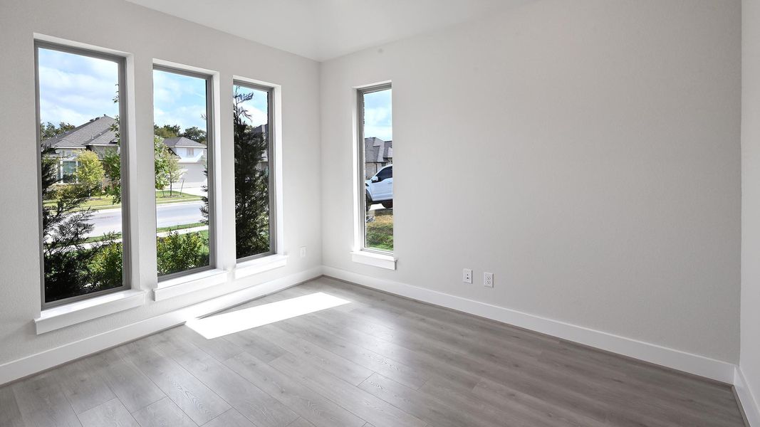 Spare room featuring baseboards and wood finished floors Spare room featuring baseboards and wood finished floors