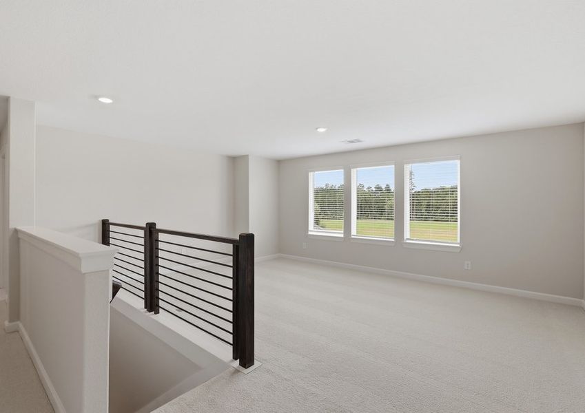 Second-floor hallway landing featuring a stair railing and windows.