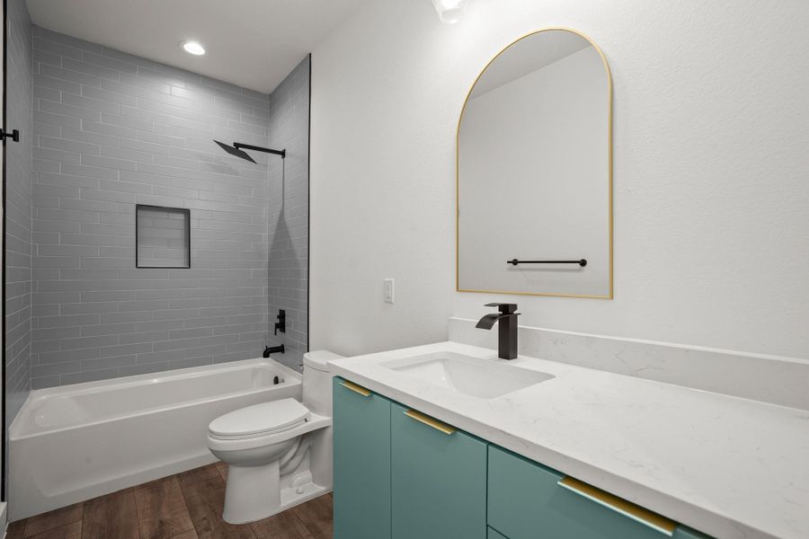 Bathroom featuring dark wood-style flooring, vanity, bathing tub / shower combination, and recessed lighting