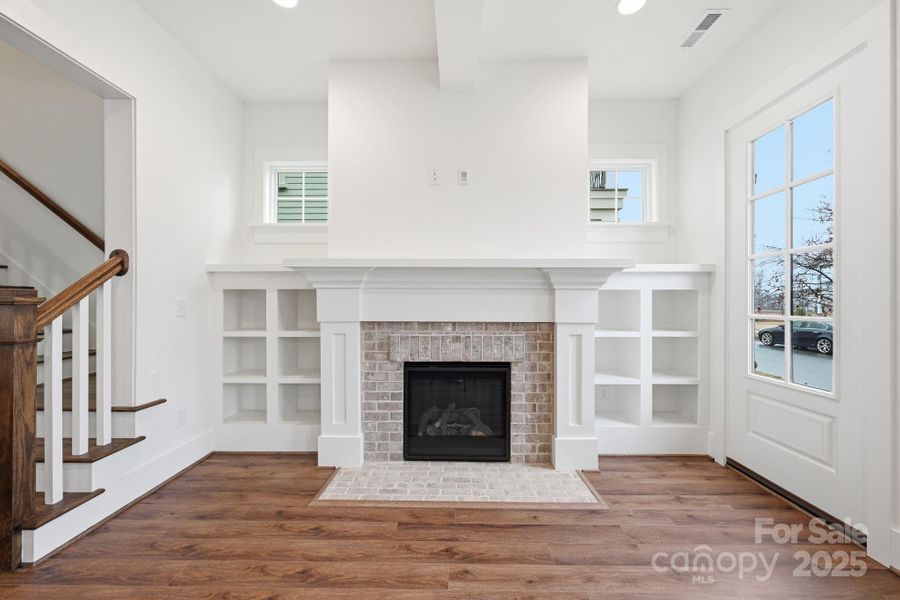Classic brick fireplace flanked by custom built-ins creates a warm and inviting space. Classic brick fireplace flanked by custom built-ins creates a warm and inviting space.