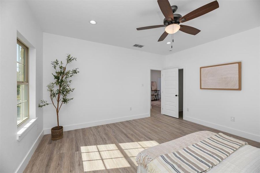 Unfurnished bedroom with wood finished floors, recessed lighting, and a ceiling fan Unfurnished bedroom with wood finished floors, recessed lighting, and a ceiling fan
