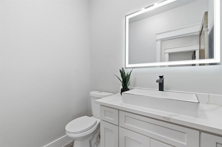 Bathroom featuring vanity and toilet