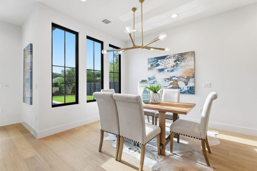Dining room with light wood-type flooring, a chandelier, and recessed lighting