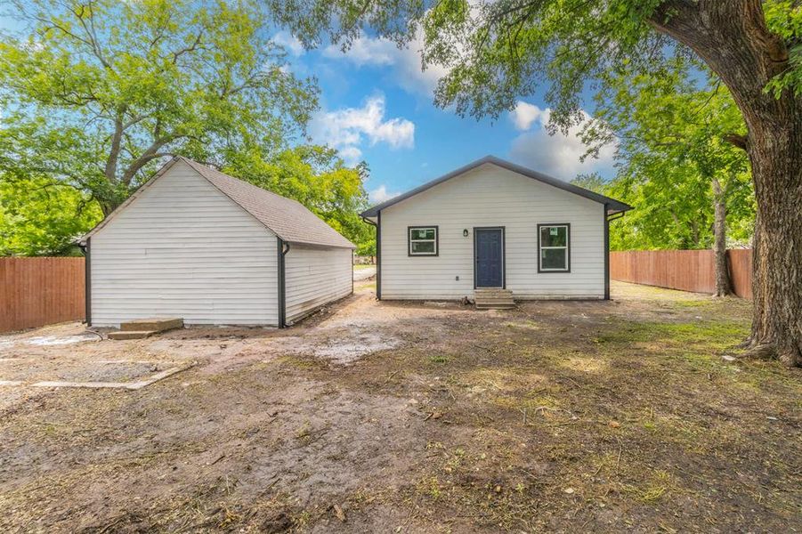 Back of property featuring entry steps and a fenced backyard Back of property featuring entry steps and a fenced backyard