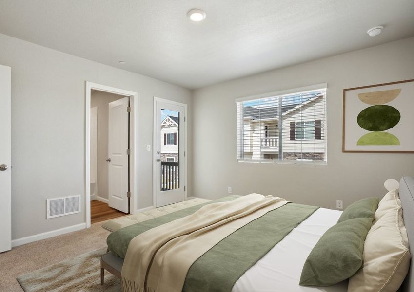 The master bedroom is spacious with windows.