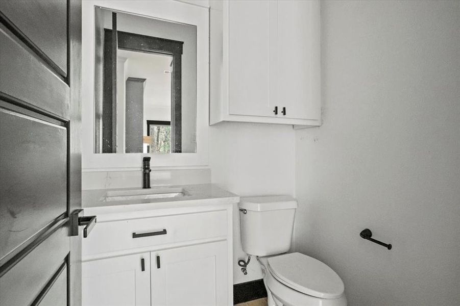 Bathroom featuring vanity and toilet