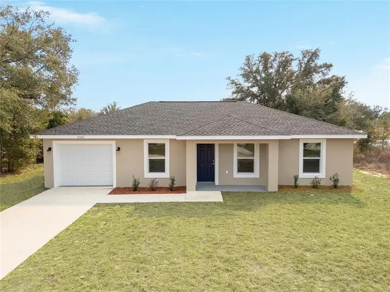 Front exterior of a new home in , Ocala, FL, highlighting curb appeal (Image 1). Front exterior of a new home in , Ocala, FL, highlighting curb appeal (Image 1).
