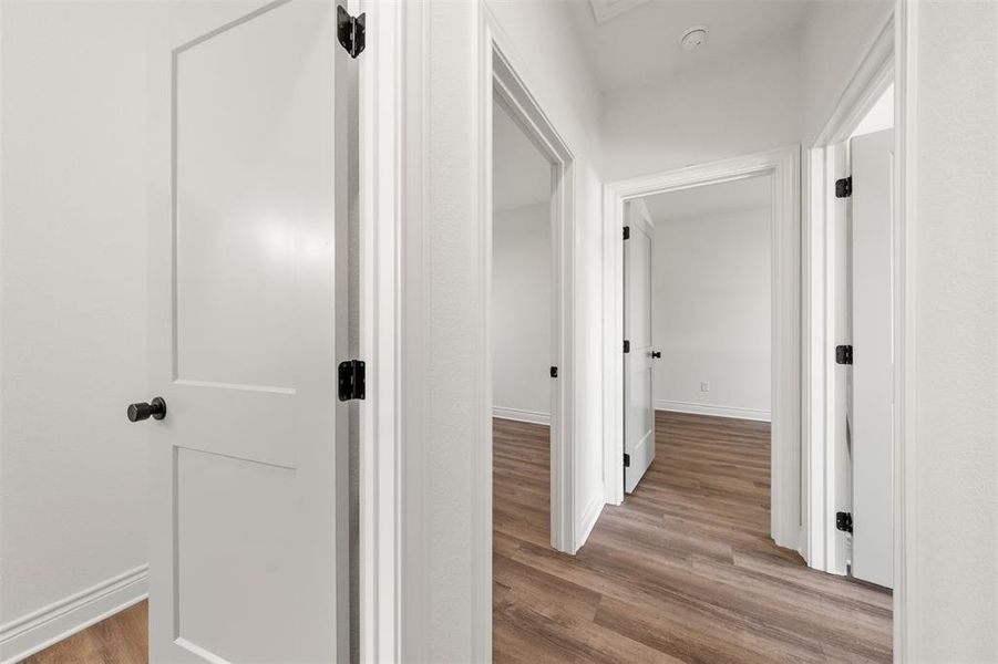 Hallway with light wood finished floors and baseboards Hallway with light wood finished floors and baseboards