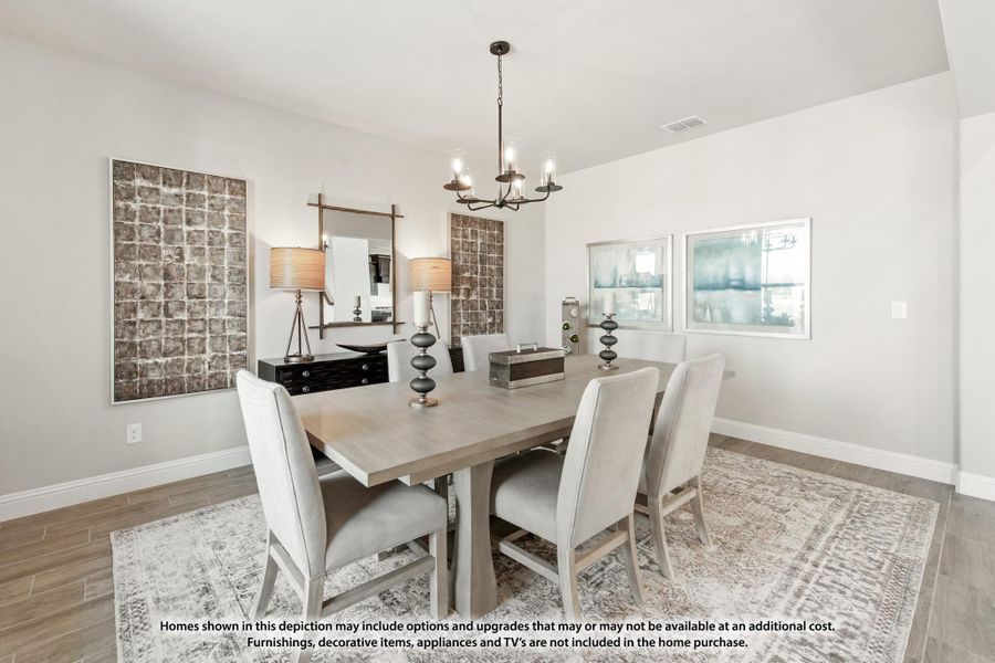 Dining room with gray wood table, six upholstered chairs, chandelier, and hardwood floors Dining room with gray wood table, six upholstered chairs, chandelier, and hardwood floors