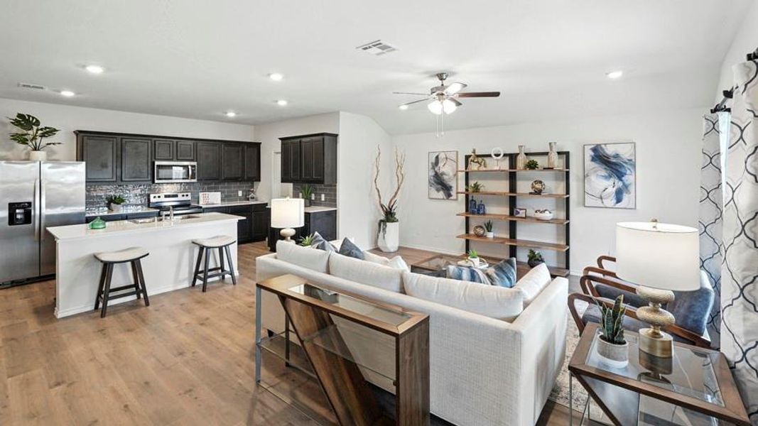 Living room featuring ceiling fan, recessed lighting, and light wood-style flooring Living room featuring ceiling fan, recessed lighting, and light wood-style flooring