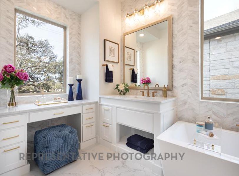 Full bath featuring marble finish floor, vanity, and a bath Full bath featuring marble finish floor, vanity, and a bath