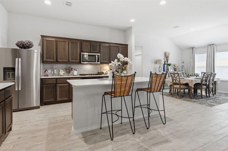 Large kitchen with bar and open to dining