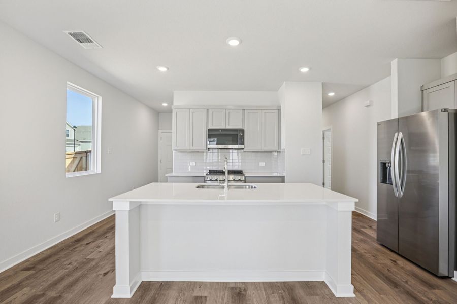 A kitchen with white cabinets. A kitchen with white cabinets.