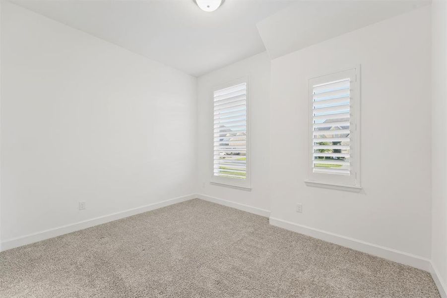 Guest Bedroom has Hunter Douglas Heritance Wood Shutters