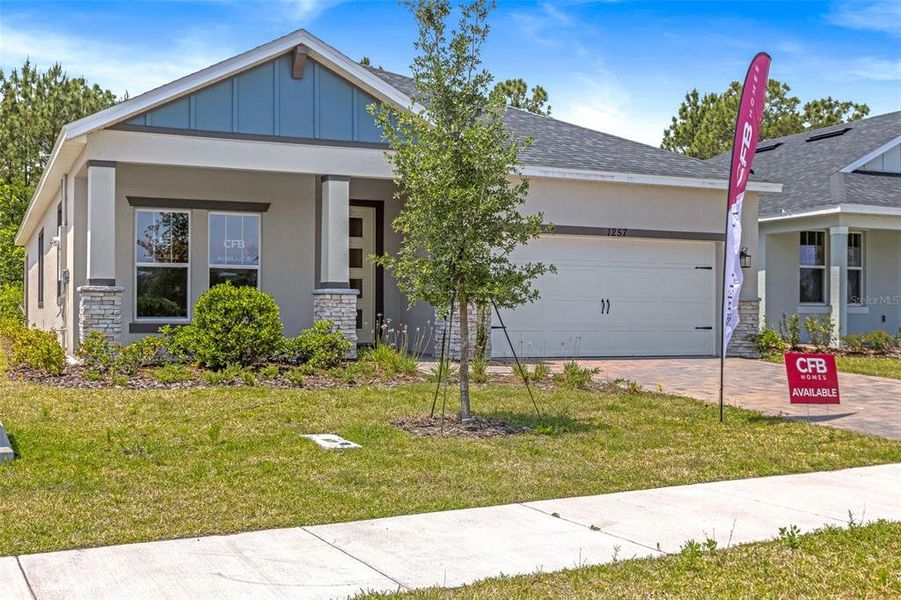 Front exterior of a new home in Gray Hawk at Hole Two, Daytona Beach, FL, highlighting curb appeal (Image 23).