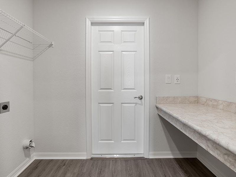 A dedicated laundry room with a convenient drop zone is located at the garage entry - Remy by Highland Homes A dedicated laundry room with a convenient drop zone is located at the garage entry - Remy by Highland Homes